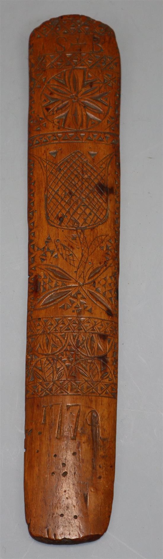 An 18th century treen stay busk dated 1770 and initialled SL length 30cm